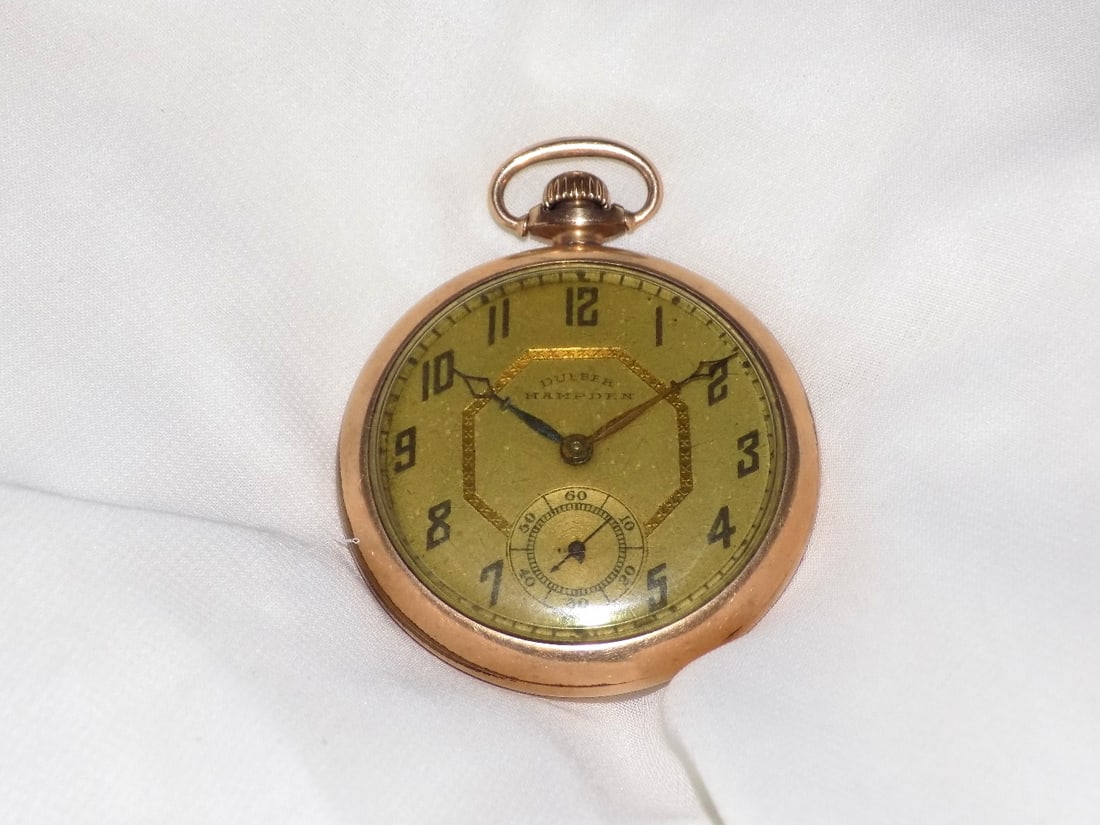 Antique 14k gold filled pocket watch Dueber Hampden: Antique 14k gold filled pocket watch Dueber Hampden marked on dial as shown in photo. 15j. Decorated case. Running at time of listing. 1 ¾ wide. In very good original as found condition. Great 