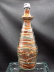 Vintage sand art bottle with grapes and leaves on bottle