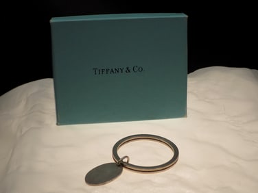 Signed Tiffany sterling key ring with original box.