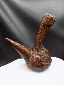 Elaborate tooled leather wine decanter.
