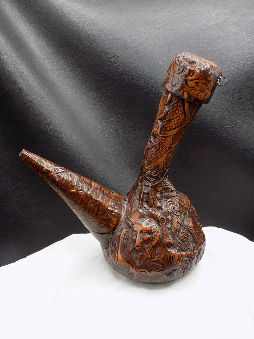 Elaborate tooled leather wine decanter.: Elaborate tooled leather wine decanter. 3 dimentional ornate leather over glass. Looks like Don Quixote and I can not tell on other. Writing on top. In very good original as found condition. Beautiful