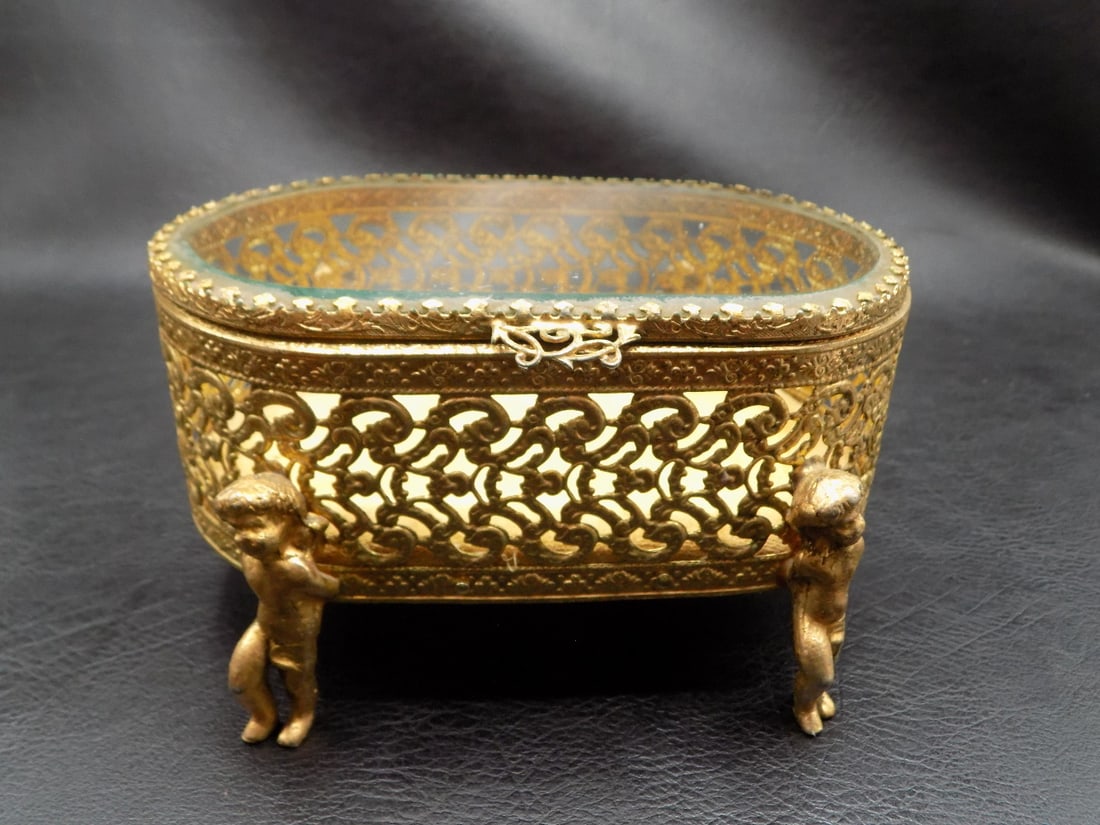 Charming vintage filigree jewelry box with figures.: Charming vintage filigree jewelry box with figures. Beveled glass lid. Original patina.. . In very good original as found condition. Great quality and detail. 5 7/8 wide x 4 7/8 depth x 2 7/8 inches t