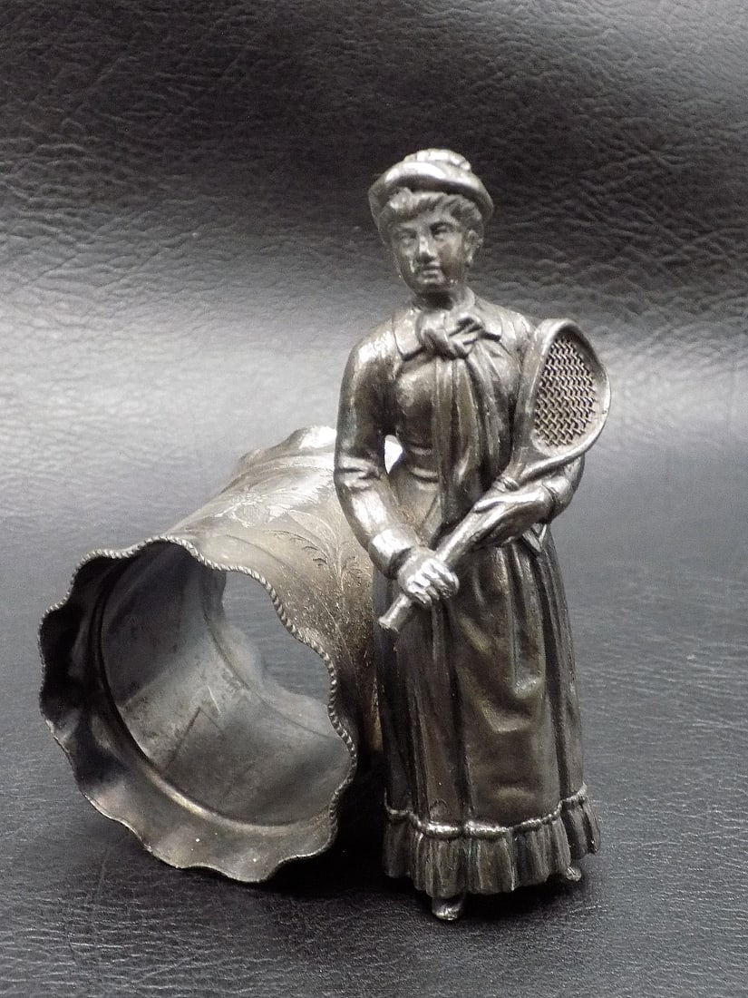 Exceptional antique lady tennis player napkin ring: Exceptional antique lady tennis player napkin ring. Marked Meriden as shown in photo. In very good original as found condition. Great quality and detail. 3 7/8 inches tall. For in house shipping, plea