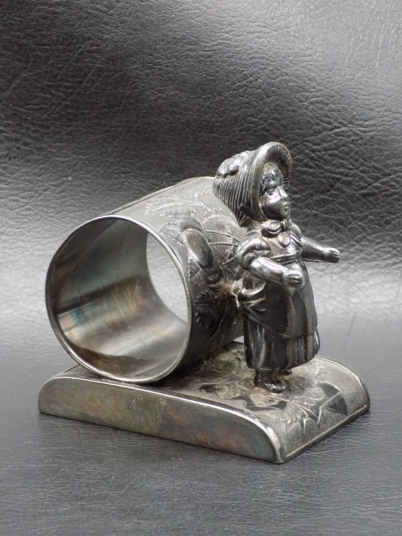 Fancy antique Kate Greenway figural napkin ring.: Fancy antique Kate Greenway figural napkin ring. Marked Rockford on bottom as shown in photo. In very good original as found condition. Great quality and detail. 3 inches tall. For in house shipping, 