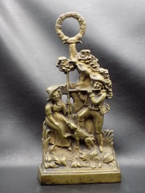 Antique cast iron door stop with Colonial scene.