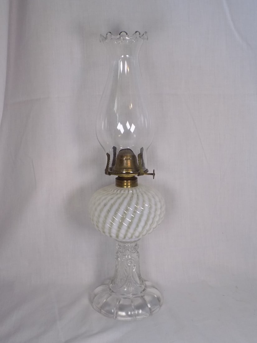 Antique white opalescent Sheldon swirl kerosene lamp: Antique white opalescent Sheldon swirl kerosene lamp. Beautiful colors. In very good original as found condition. Great quality and detail. 16 ½ to top the chimney. Base 10 inches. For in house