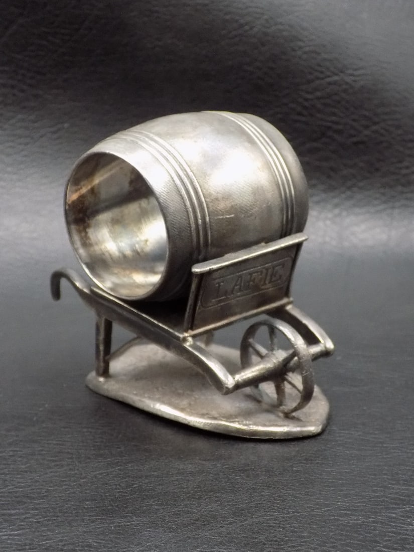 Unusual antique napkin ring with wheel barrel: Unusual antique napkin ring with wheel barrel. Marked James Tuft on bottom as shown in photo. Marked Lafie on barrel. In very good original as found condition. Great quality and detail. 2 ¾ inc