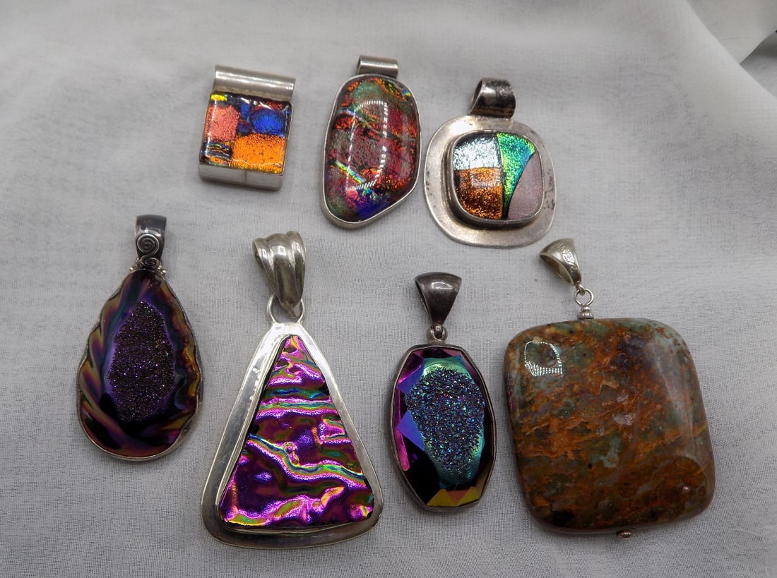 Seven vintage multi color dichroic and other glass sterling silver pendants: Seven vintage multi color dichroic and other glass sterling silver pendants. Marked sterling and Mexico as shown in photos. Triangle pendant 2 ¼ inches, included loop, x 1 ¼ wide Beautif