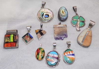 Eleven vintage multi color dichroic and other glass sterling silver pendants