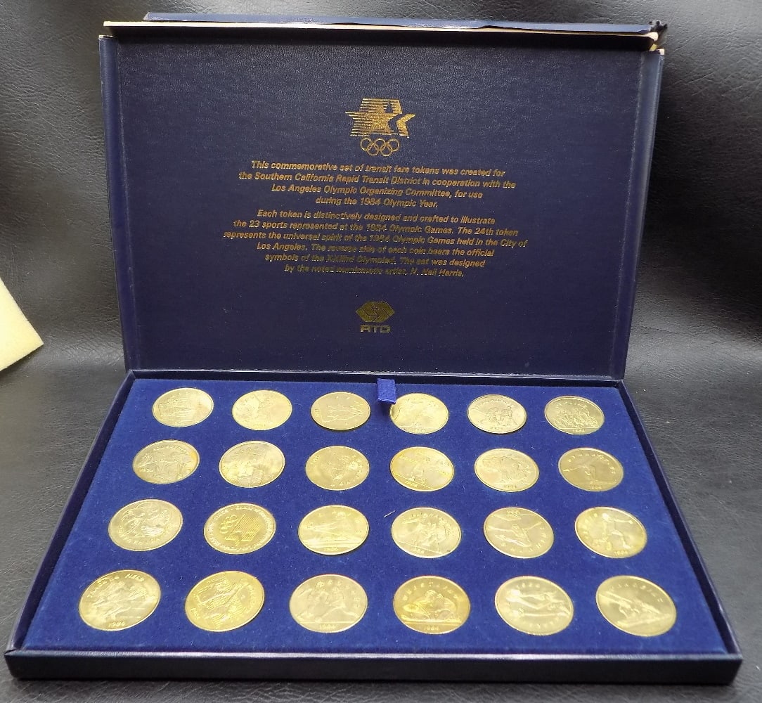 Games of the XXIIIrd Olympiad Los Angeles 1984: Games of the XXIIIrd Olympiad Los Angeles 1984 - Transit Token Set of 24 Coins. In very good original as found condition. Great quality and detail. 20 inches long For in house shipping, please call Mi