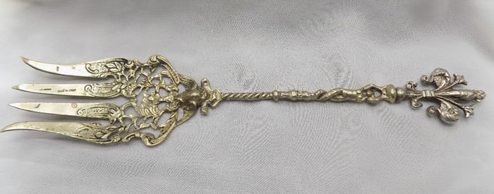 Large fancy vintage silver serving fork with nude