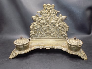 Ornate antique brass double inkwell with cupids.