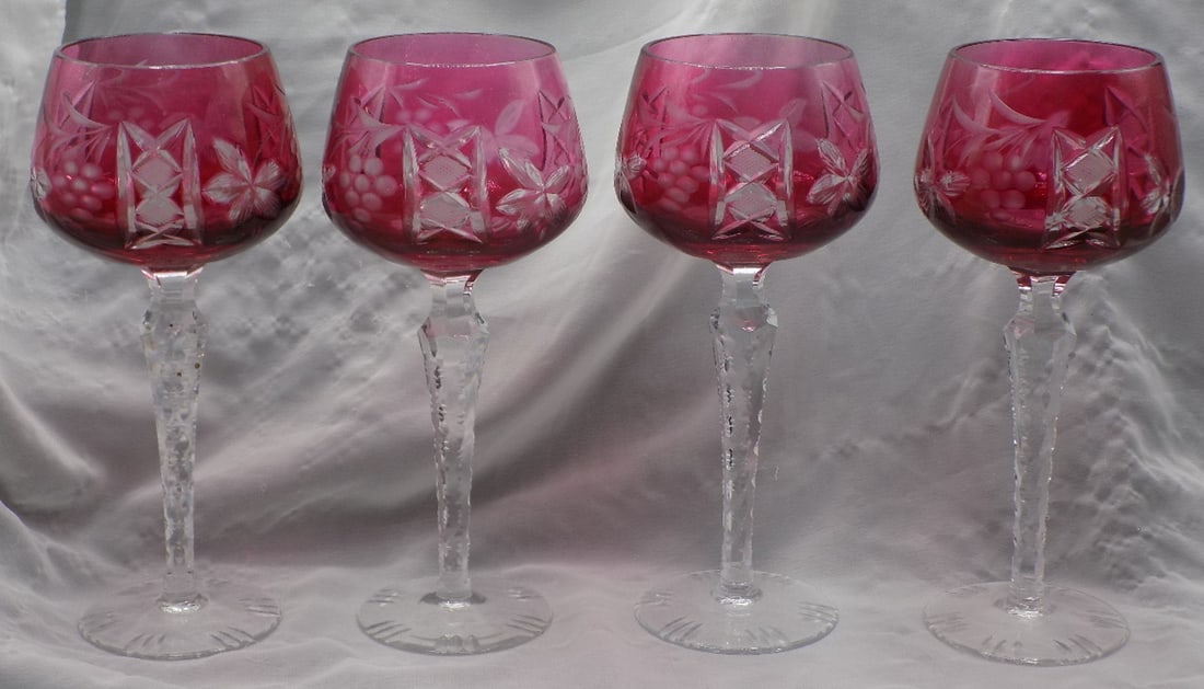 Set of four cut glass cranberry to clear wine glasses: Set of four cut glass cranberry to clear wine glasses. Beautiful colors. In very good original as found condition. Great quality and detail. White lines are camera flash reflection. 7 7/8 inches tall