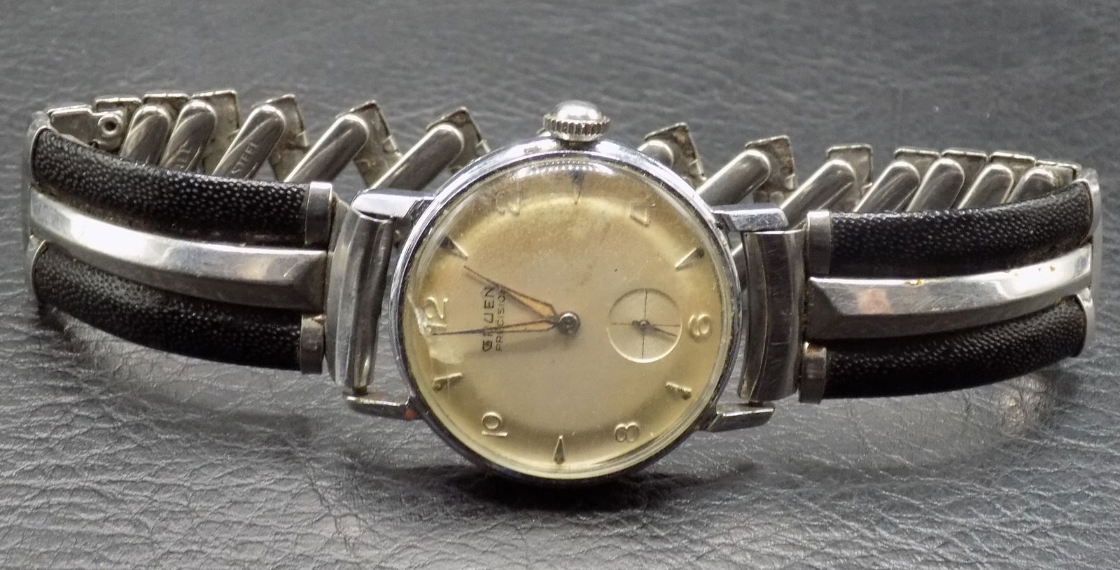 Vintage Gruen Precision wristwatch: Vintage Gruen Precision wristwatch. 30 mm Running at time of listing. Could not get back removed. Watch band is stretched out as shown in photos. For in house shipping. Please call Mike at Thriftiques