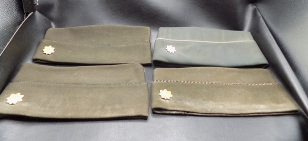 Four World War II military Garrison caps. With metal emblem