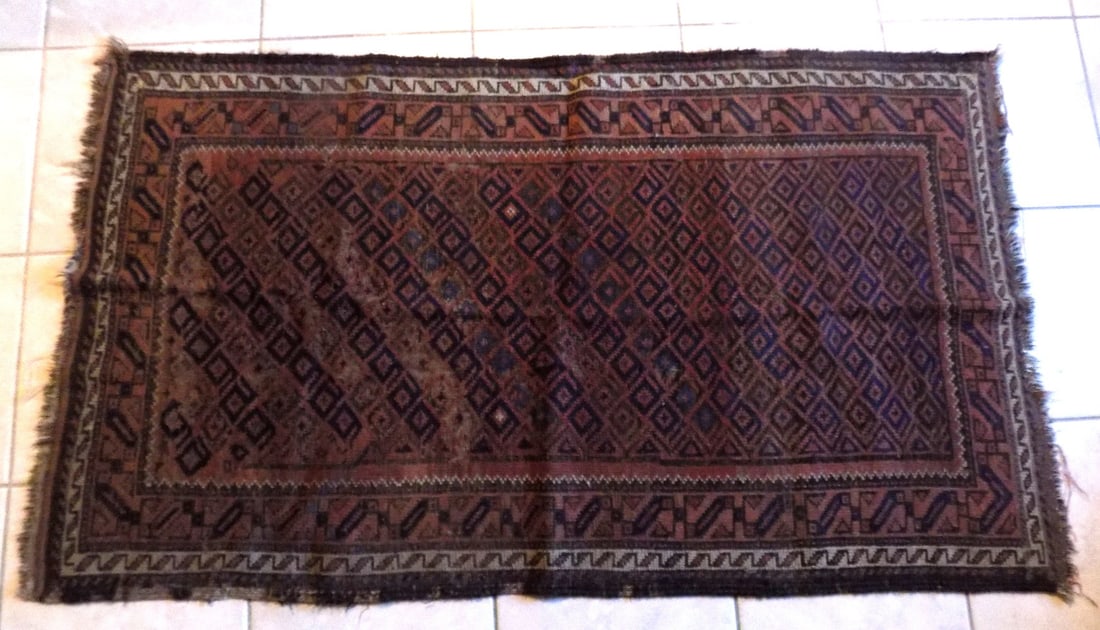 Antique Oriental hand made rug. With wear as shown in photos.: Antique Oriental hand made rug. With wear as shown in photos. 51 x 30 inches. For in house shipping, please call Mike at Thriftiques 319-321-0613