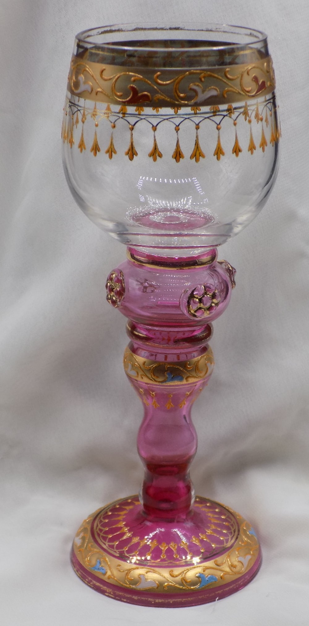 Exceptional antique Moser hand decorated art glass wine glass: Exceptional antique Moser hand decorated art glass wine glass. Lots of gold. Cranberry glass stem. Beautiful colors. In very good original as found condition. Great quality and detail. White