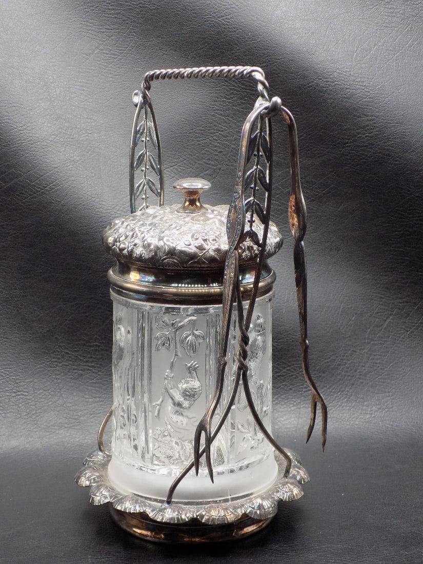 Exceptional decorated antique Reed and Barton pickle castor.: Exceptional decorated antique Reed and Barton pickle castor. Marked on insert and holder as shown in photo. Pressed glass insert with peacock, cherub, stork and other three dimensional design. With to