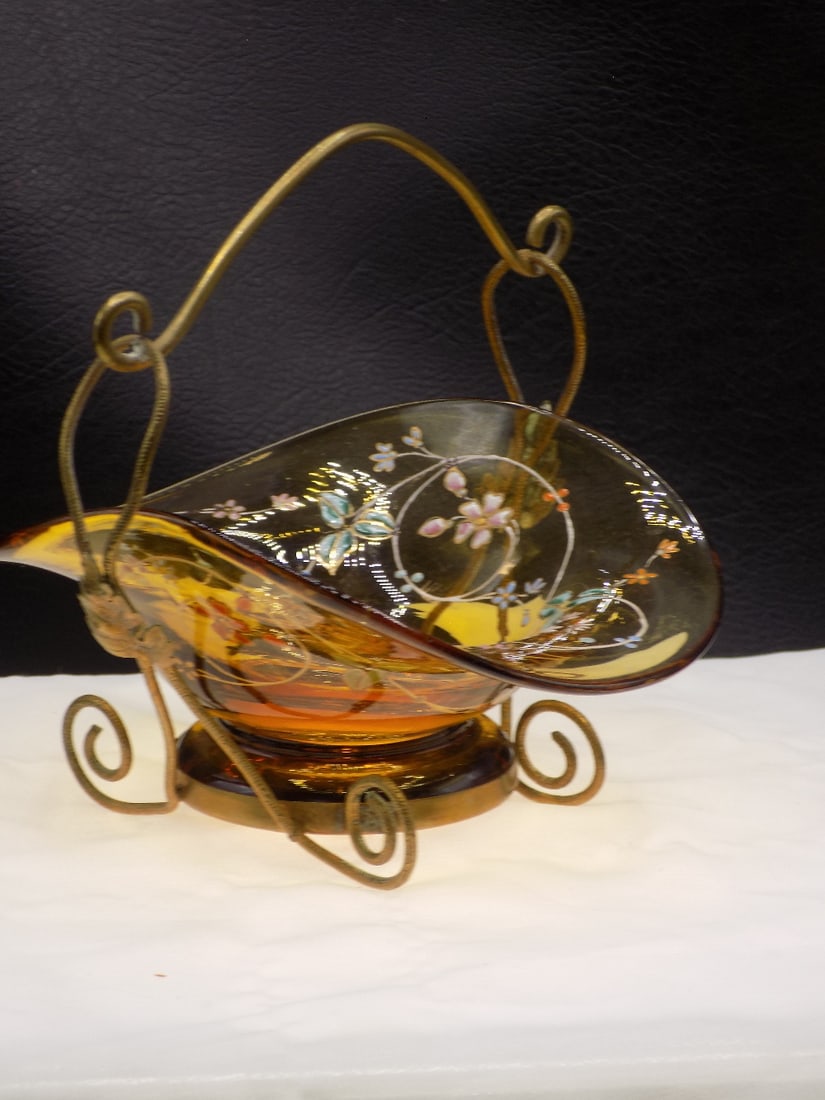 Antique floral decorated art glass basket in holder: Antique floral decorated art glass basket in holder. Amber glass basket. Brass frame holder. Beautiful colors. In very good original as found condition. Frame is 4 5/8 tall. Bowl 4 7/8 inches