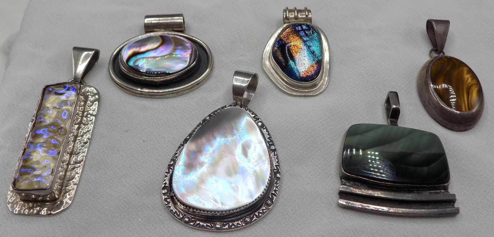 Six sterling silver pendants with semi-precious stones: Six sterling silver pendants with semi-precious stones. Some are marked Mexico, sterling and artist marks as shown in photos. Longest 2 3/8 inches, includes loop. Beautiful colors. In very good origin