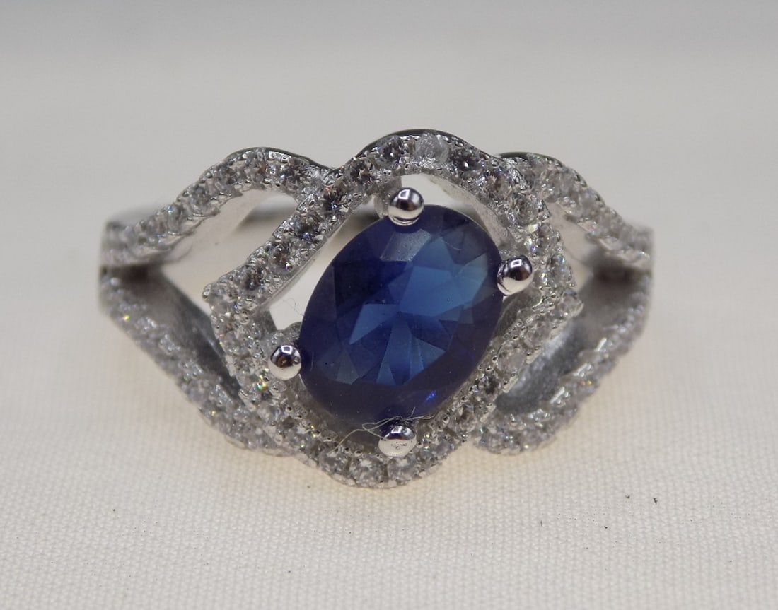 Beautiful 2 cwt blue sapphire and topaz sterling silver ring: Beautiful 2 cwt blue sapphire and topaz sterling silver ring. Lab created sapphire. Size 5 ½. For in house shipping, please call Mike at Thriftiques 319-321-0613