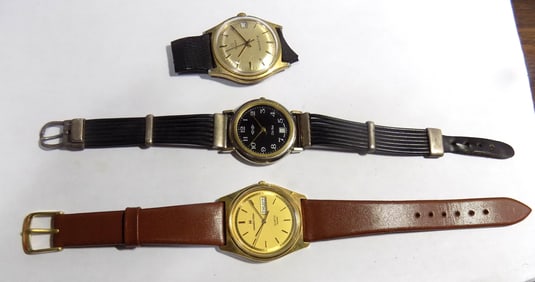 Three vintage wrist watches including Hamilton and vintage broach