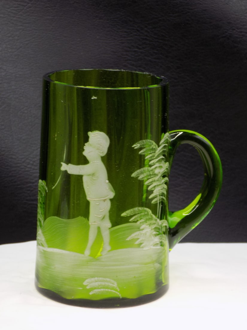 Charming vintage enamel decorated art glass mug with child playing: Charming vintage enamel decorated art glass mug with child playing. Faint mark on bottom Made in Bohemia as shown in photo. Ribbed glass. Beautiful colors. In original condition with small