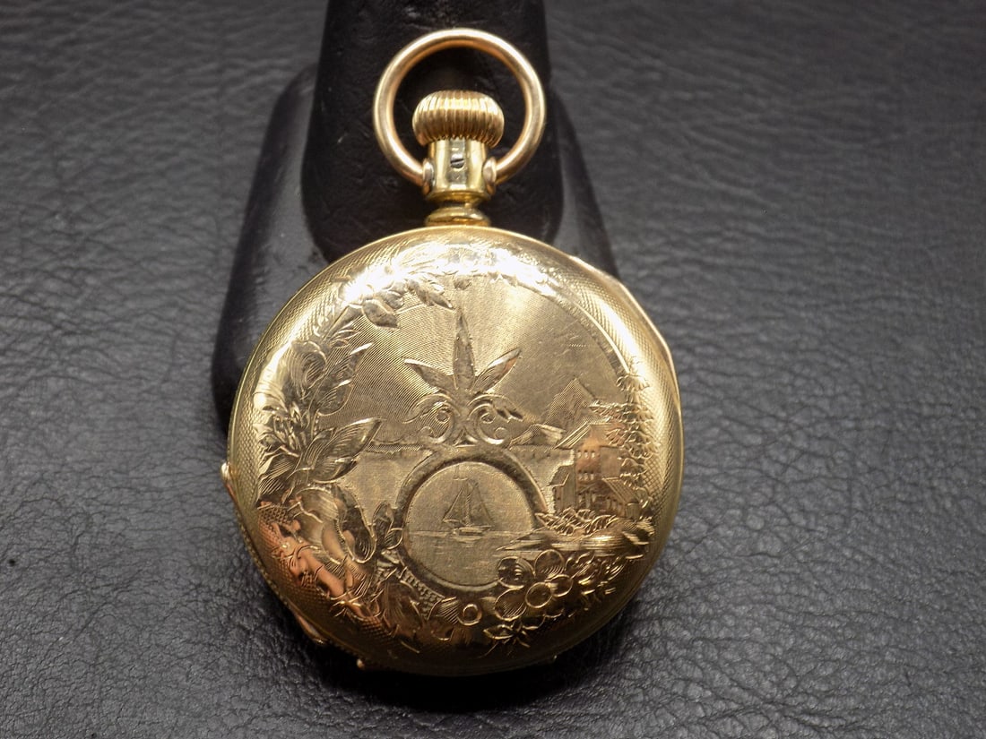 Antique Illinois pocket watch with fancy gold fill case: Antique Illinois pocket watch with fancy gold fill case. White porcelain dial. 1 ½ in. running. Please see photos for condition and serial numbers. Running at time of listing. In very good orig