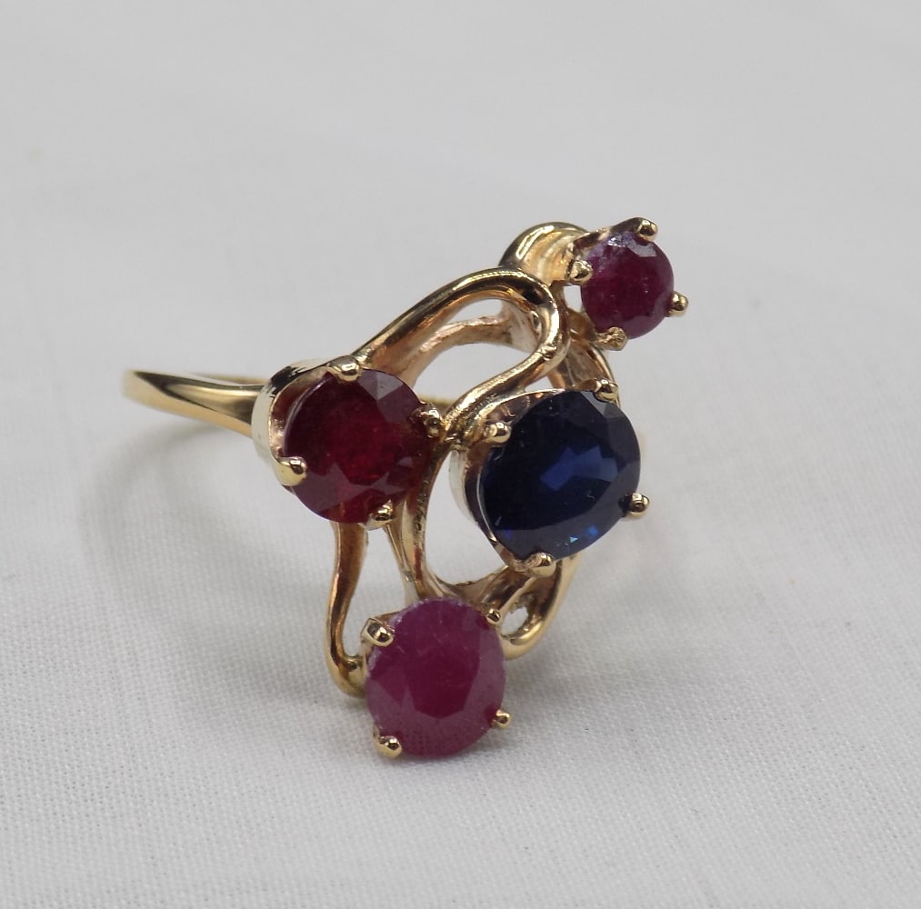 Ruby and Sapphire 10 k gold freeform ring: Ruby and Sapphire 10 k gold freeform ring . With appraisal and description. No credit cards. Payment through Live Auctioneer or cashier’s check For in house shipping, please call Mike at Thriftiques