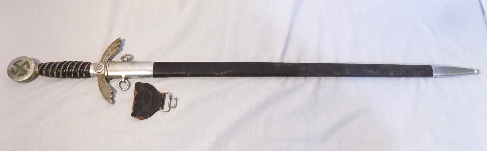 WWII German Luftwaffe officers sword: WWII German Luftwaffe officers sword. Mared on blade as shown in photo. In very good original as found condition. Leather tab separated as shown in photo. Great quality and detail. 34 ½ inches