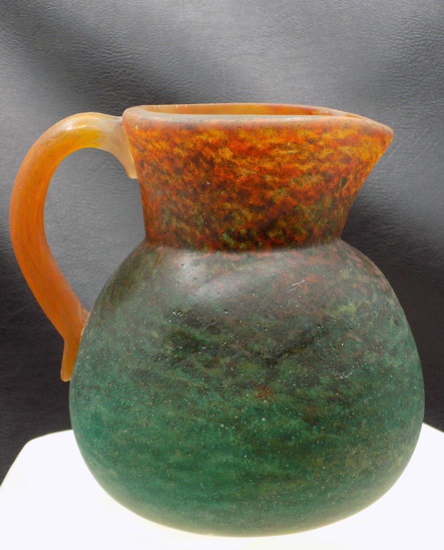 Art Nouveau art glass pitcher signed Georges De Feure: Art Nouveau art glass pitcher signed Georges De Feure. 1900 to 1910. Marked on bottom as shown in photo. Beautiful colors. In very good original as found condition. Great quality and detail. 7 1/8 inc