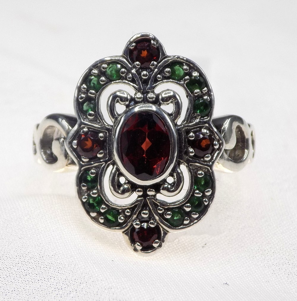 Beautiful 2 cwt garnet and emerald sterling silver ring: Beautiful 2 cwt garnet and emerald sterling silver ring. Size 7 ½. For in house shipping, please call Mike at Thriftiques 319-321-0613.