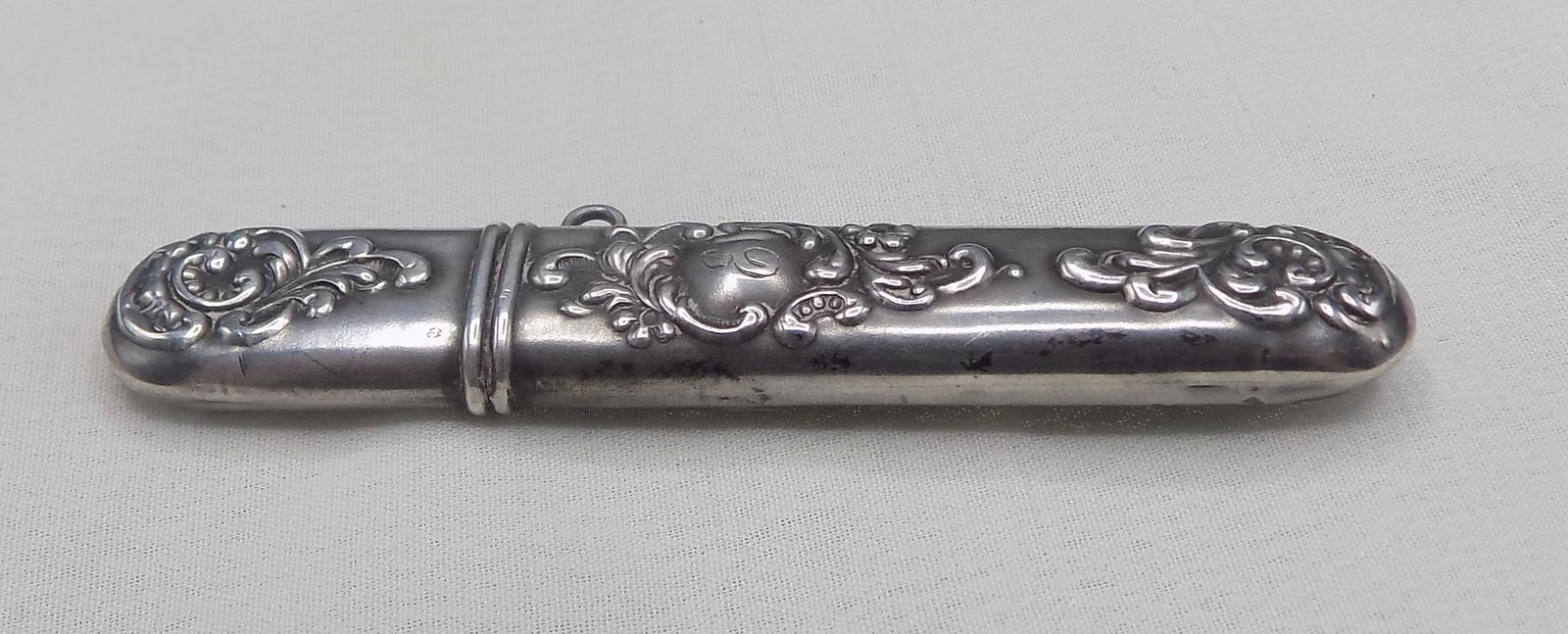 Fancy antique sterling silver sewing needle holder: Fancy antique sterling silver sewing needle holder. Marked as shown in photos. In very good original as found condition. Great quality and detail. 2 ¾ inches long. For in house shipping, please
