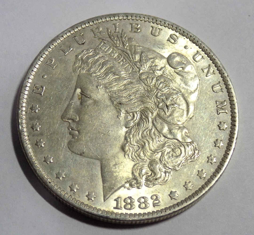 Uncirculated 1882 O Morgan silver dollar: Uncirculated 1882 O Morgan silver dollar. Please see photos for condition. For in house shipping. Please call Mike at Thriftiques 319-321-0613