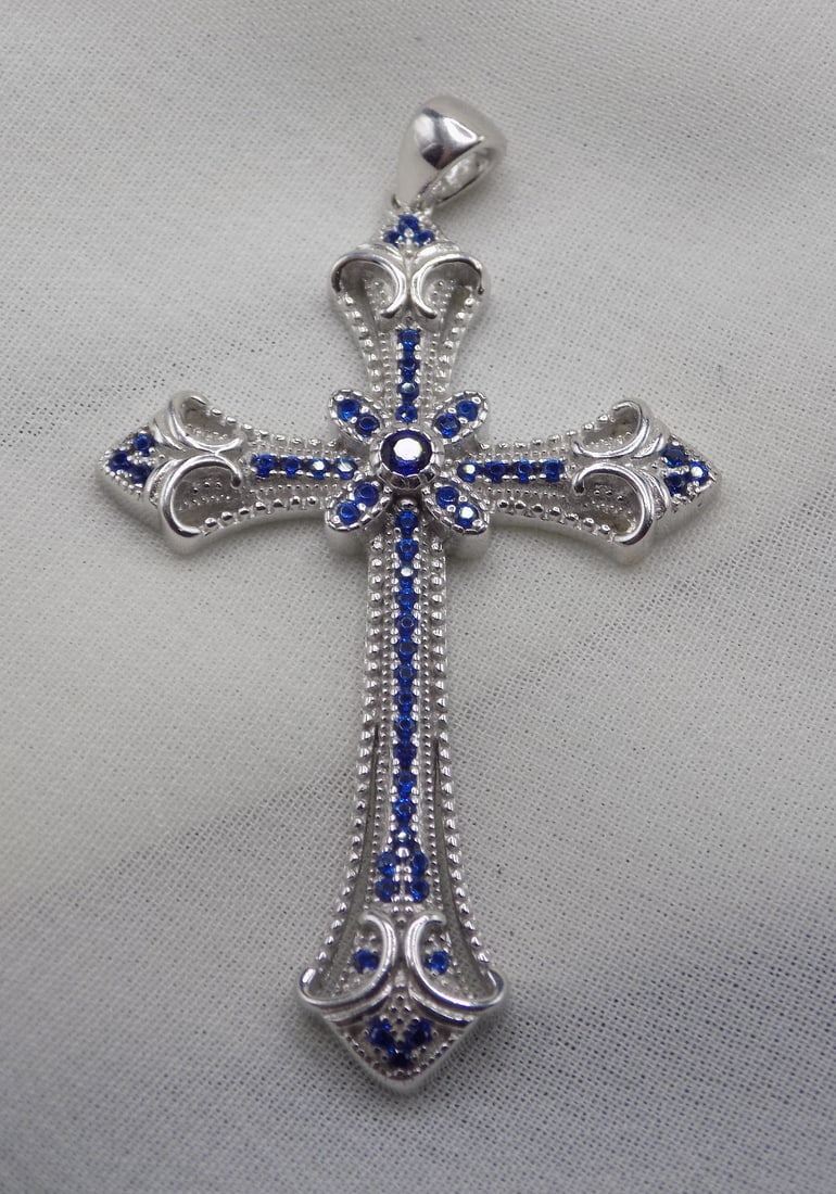 Beautiful 2 ct blue sapphire sterling silver cross pendant: Beautiful 2 ct blue sapphire sterling silver cross pendant. 1 5/8 inches tall. For in house shipping, please call Mike at Thriftiques 319-321-0613