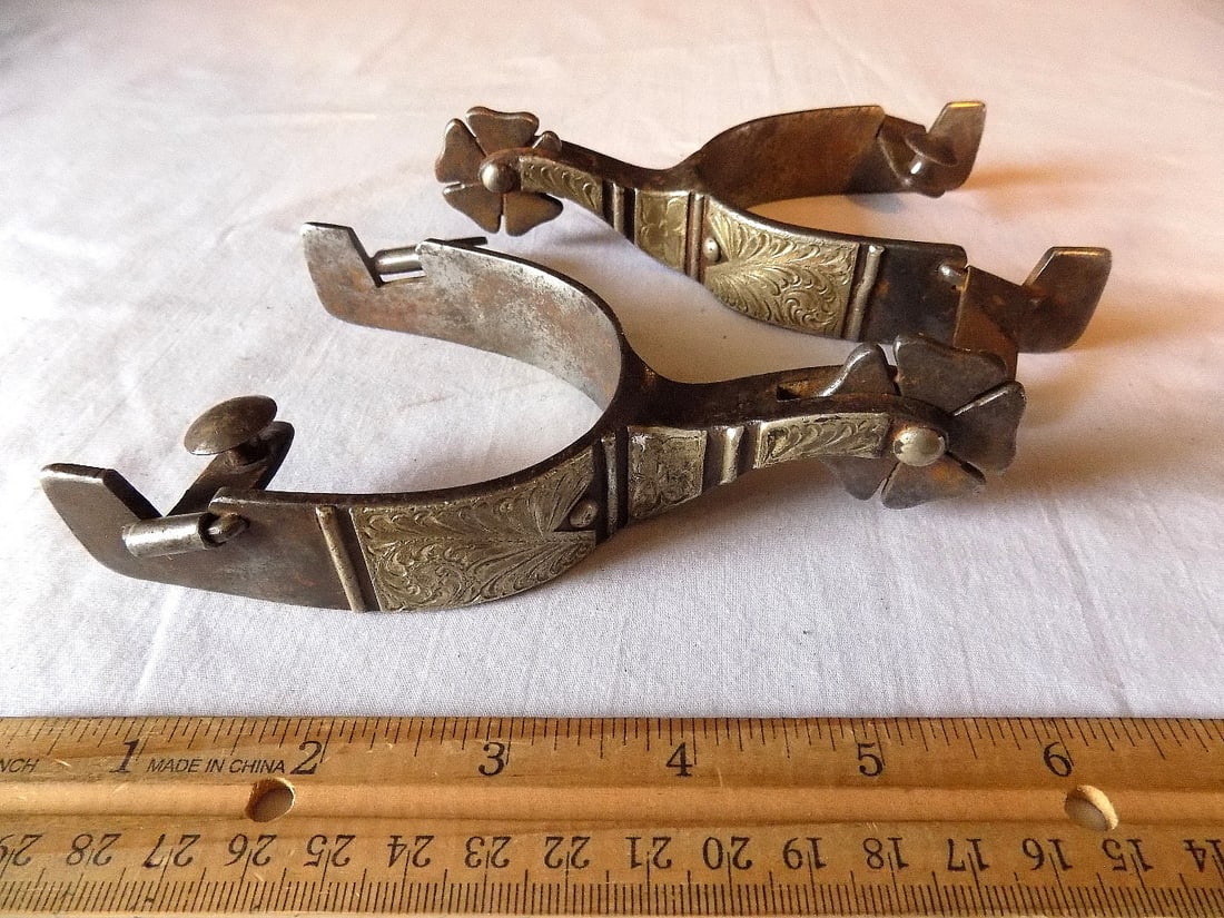 Fancy antique silver overly engraved spurs marked C M: Fancy antique silver overly engraved spurs marked C M. Please see photos with ruler for size. In very good original as found condition. Great quality and detail. For in house shipping, please call Mik
