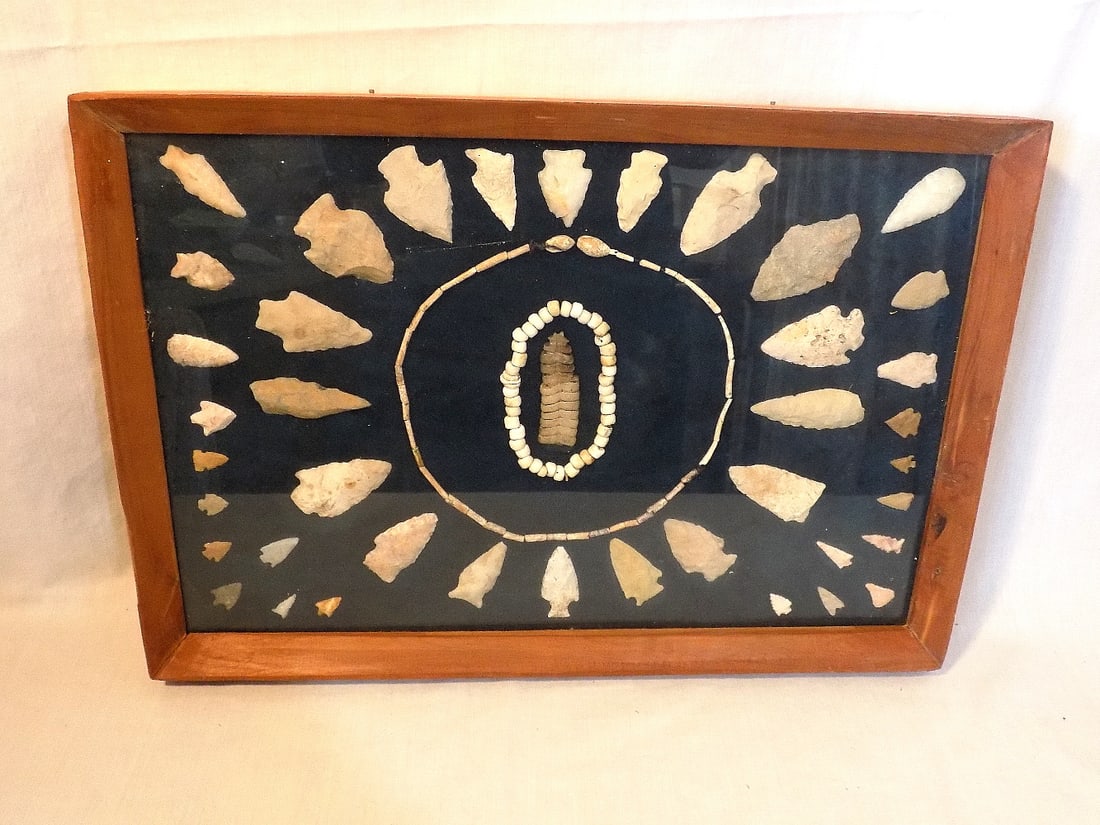Antique collection of Native American Indian arrow heads: Antique collection of Native American Indian arrow heads. Has rattlesnake tail and beads in center. In sealed case. In very good original as found condition. Great quality and detail. Longest arrowhea