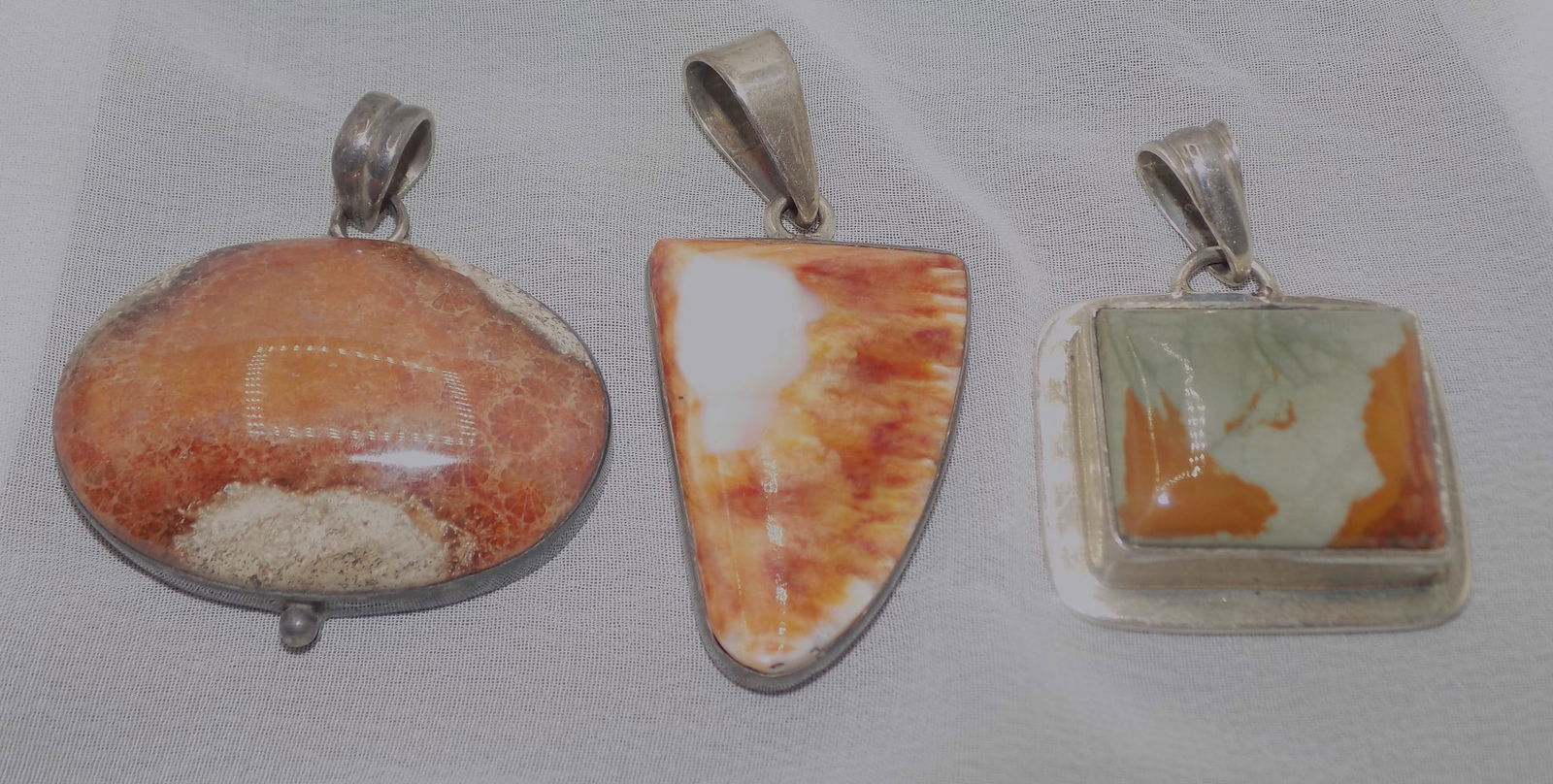 Three vintage marked sterling pendants: Three vintage marked sterling pendants. Sunstone, Montana moss agate 2 1/8, inches and jasper. Beautiful colors. In very good original as found condition. Great quality and detail. White lines or dots