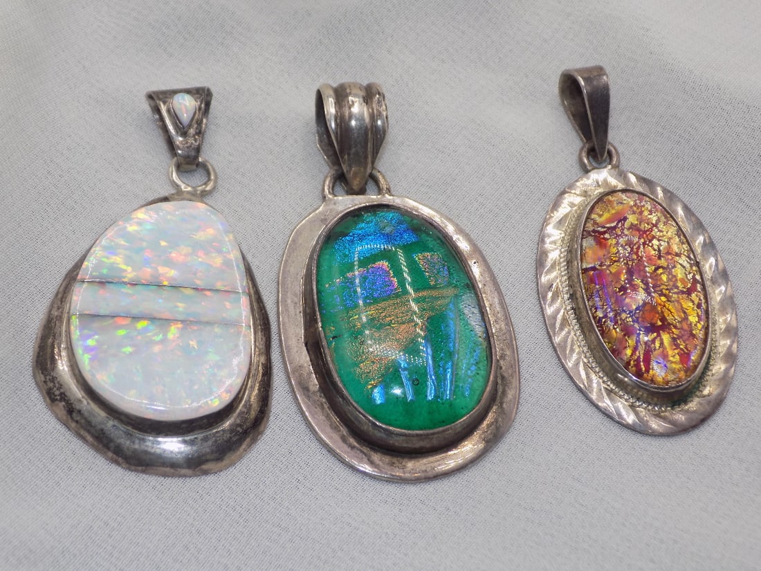 Three vintage marked sterling pendants: Three vintage marked sterling pendants. White fire opal 2 inches. Peruvian opal and dragon breath opal. Beautiful colors. In very good original as found condition. Great quality and detail. White line