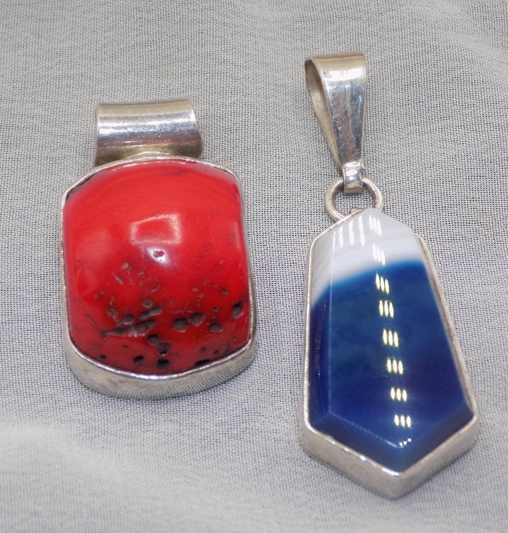Two vintage marked sterling pendants: Two vintage marked sterling pendants. Red coral. Blue and white agate is 1 7/8 inches tall. Beautiful colors. White lines or dots are camera flash reflection. In very good original as found condition.