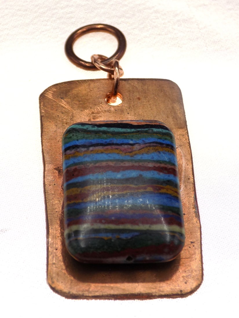 Vintage rainbow calsilica on brass pendant: Vintage rainbow calsilica on brass pendant 1 ½ inches. Beautiful colors. In very good original as found condition. Great quality and detail. For in house shipping, please call Mike at Thriftiqu