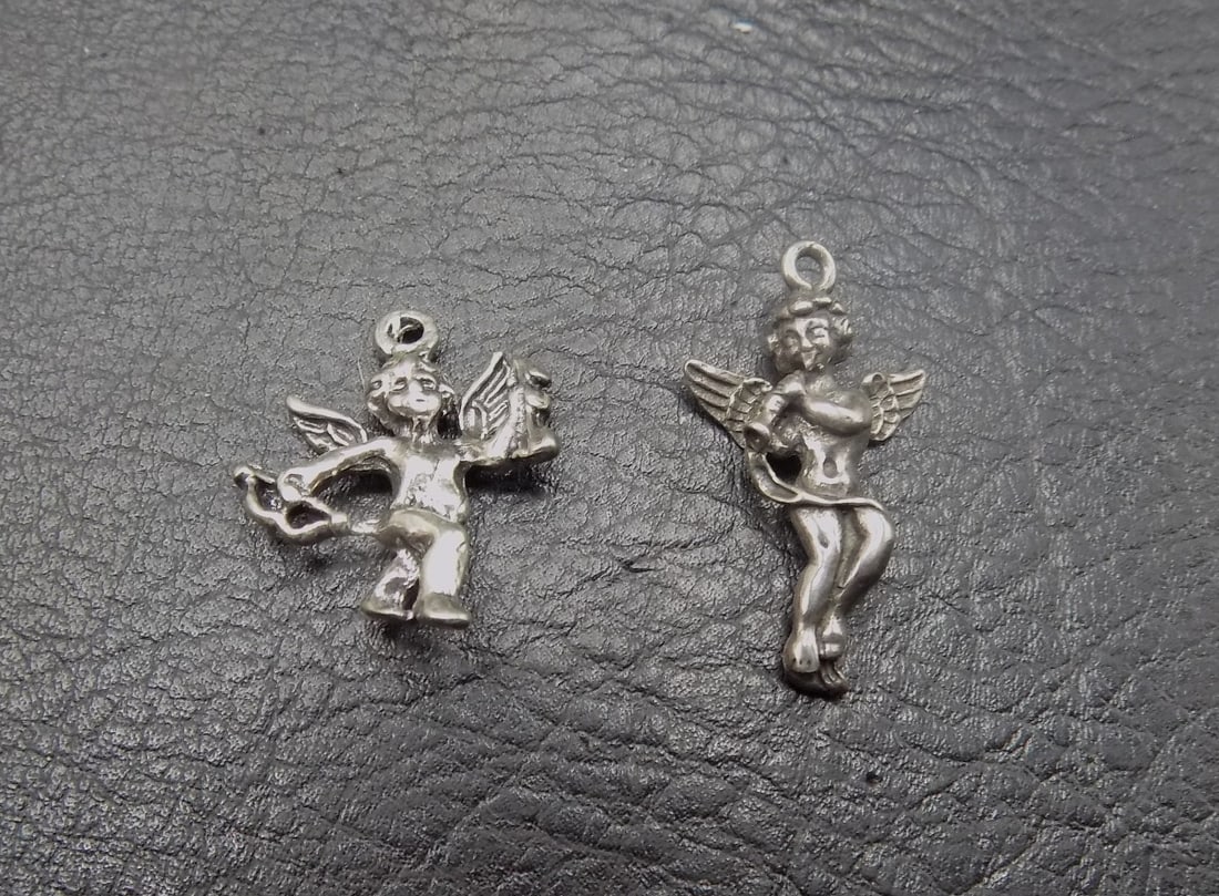 Two vintage sterling silver cherub angel pendant charms: Two vintage sterling silver cherub angel pendant charms. Marked as shown in photo, very hard to see. Beautiful colors. In very good original as found condition. Great quality and detail. Tallest is