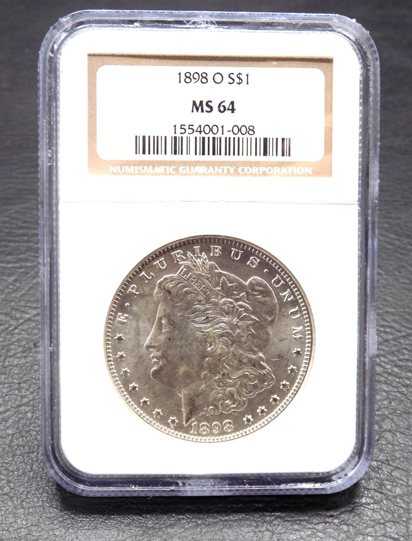 1898 O Uncirculated MS 64 Morgan silver dollar graded by NGC: 1898 O Uncirculated MS 64 Morgan silver dollar graded by NGC. Please see photos. Please call Mike at Thriftiques for in house shipping.319-321-0613