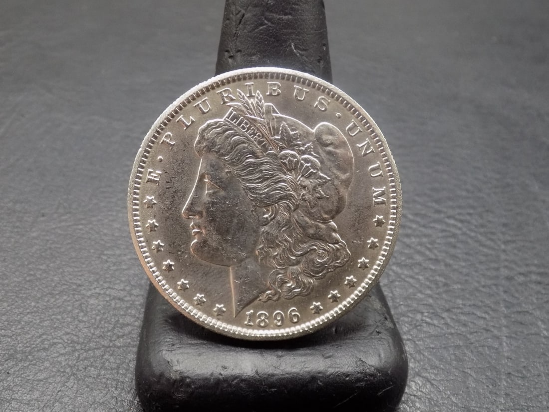 Uncirculated 1896 Morgan silver dollar: Uncirculated 1896 Morgan silver dollar. Please see photos. For in house shipping, please call Mike at Thriftiques 319-321-0613