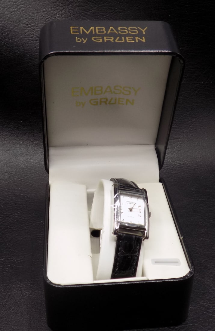 Hinged Lug Embassy Gruen mans tank wristwatch in original box.: Hinged Lug Embassy Gruen mans tank wristwatch in original box. Appears to never to be worn. In very good original as found condition. Great quality and detail. For in house shipping, please call Mike 