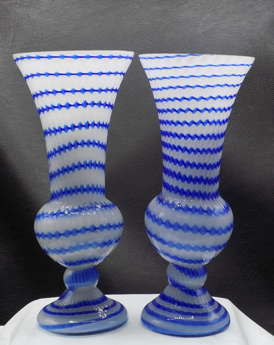 Beautiful pair of midcentury Murano art glass vases: Beautiful pair of midcentury Murano art glass vases. Ribbed with blue applied glass decoration. Great quality and detail. In very good original as found condition.. 9 1/8 tall x 3 7/8 wide at top rim.