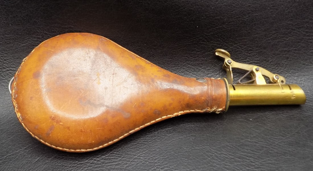 Vintage leather and brass powder flask: Vintage leather and brass powder flask. Working condition. In very good original as found condition. Great quality and detail. 8 inches long. For in house shipping, please call Mike at Thriftiques 319