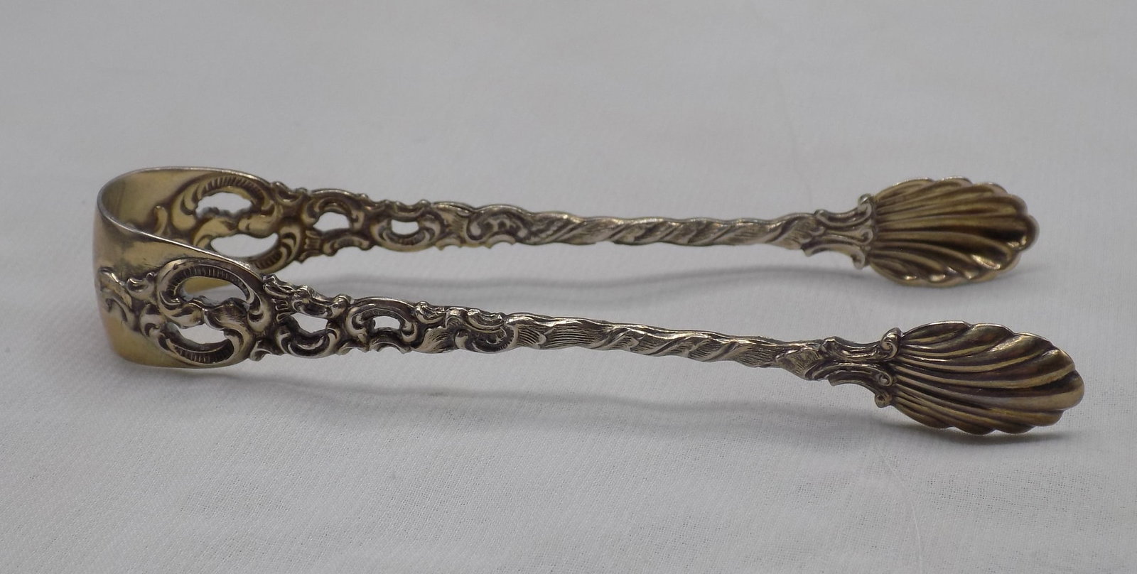 Fancy silver sugar tongs marked 830: Fancy silver sugar tongs marked 830, near sterling. Marked as shown in photo. In very good original as found condition. Great quality and detail. 13.2 grams. 3 ½ inches long. For in house shippin