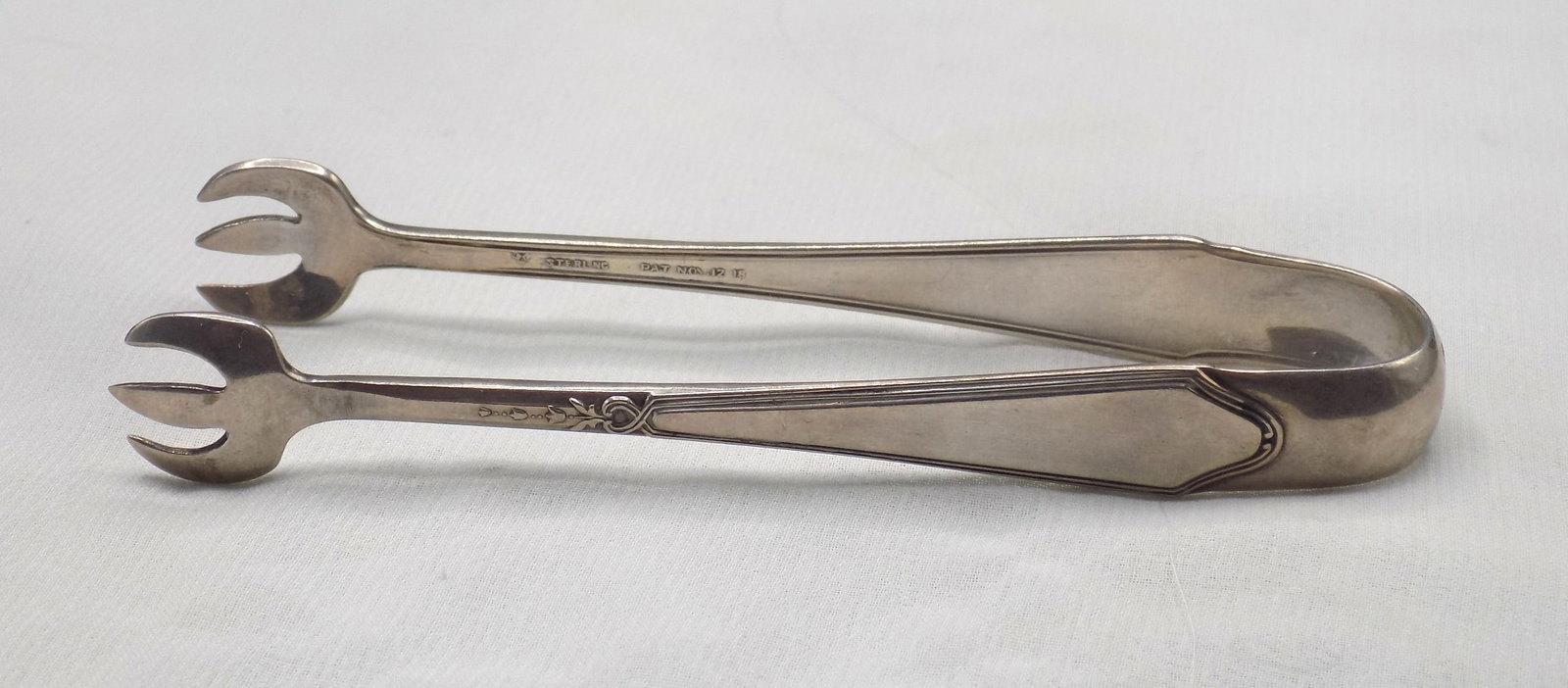 1918 sterling sugar tongs. Marked as shown in photos (1 of 4)