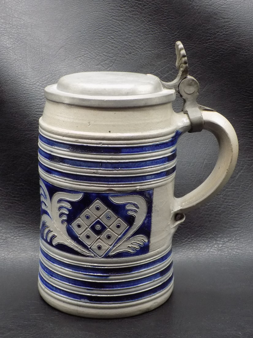 Vintage German beer stein with three dimensional decoration: Vintage German beer stein with three dimensional decoration. Marked on bottom as shown in photo. Nicely decorated. Beautiful colors. In very good original as found condition with small fleabites on ri